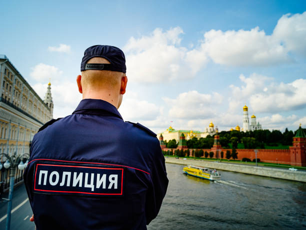 Moscow, Russia - September 2017: Russian young policeman looking at Kremlin from the bridge