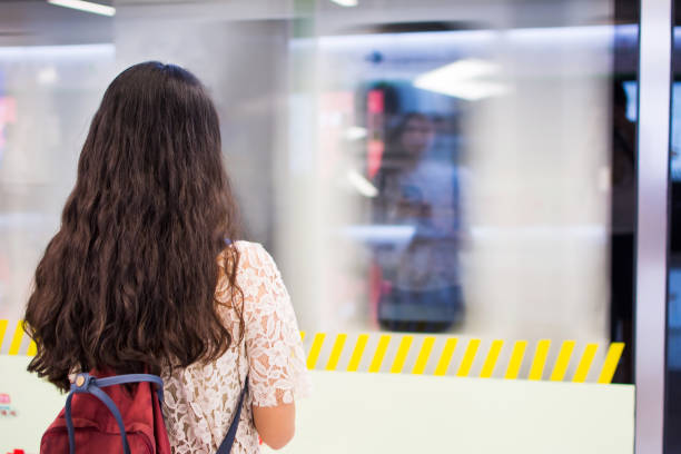 istock Girl waiting for a train at the subway station 858810016