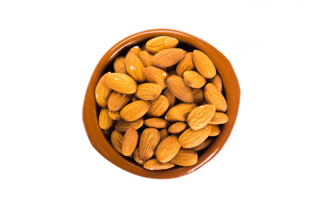istock Group of almonds placed in a bowl on a white background 858814612