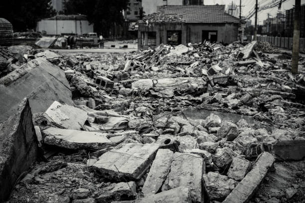 Interior of old factory buildings destroyed. Ruins of industrial enterprise, dark debris destroyed factory premises in factory as result of economic crisis and earthquake.