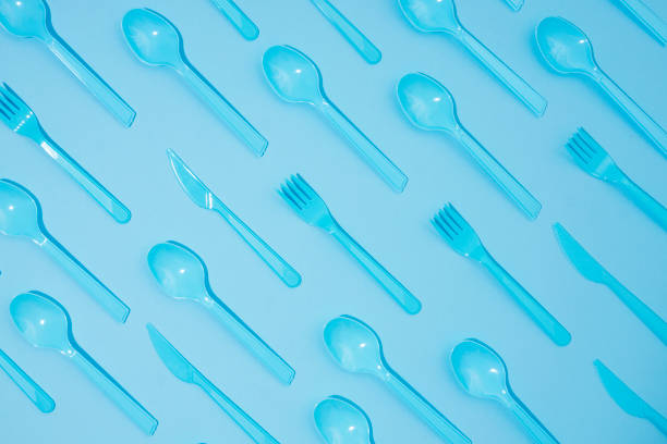 istock Blue spoons,knifes and forks on blue background 858825014