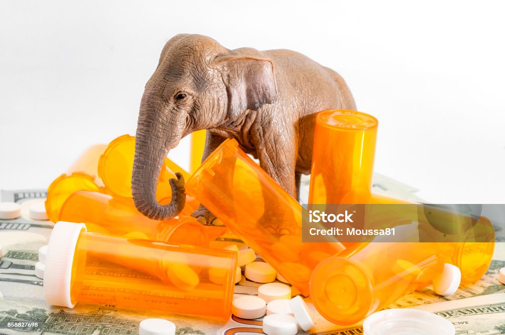 AHCA and the repeal and replace of ACA American Health Care Act or AHCA and the repeal and replace of the Affordable Care Act or ACA concept with elephant representing the republican party, stuck in a bunch of money and prescription pills Insurance Stock Photo