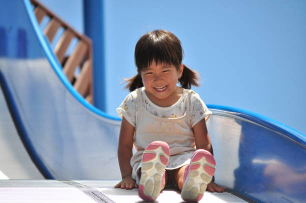 istock Girls playing in the park 858834680
