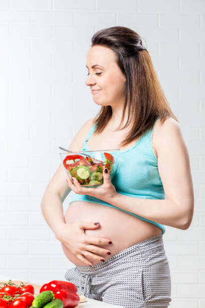 istock Satisfied woman eats a delicious vegetable salad 858848582