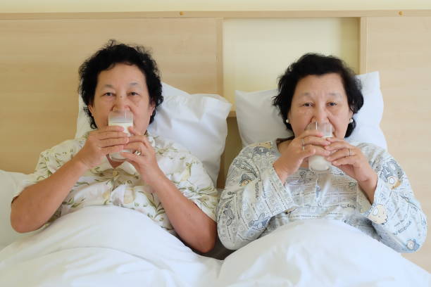 istock Asian senior woman drinking milk on bed 858848810