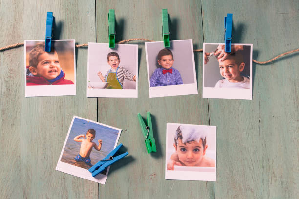 istock Child photographs hanging on a clothesline 858855598