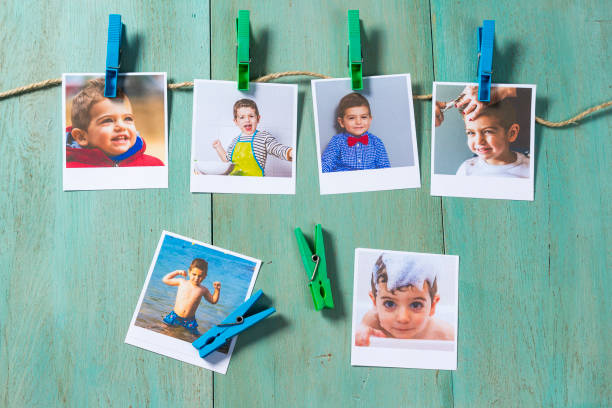 istock Child photographs hanging on a clothesline 858855602