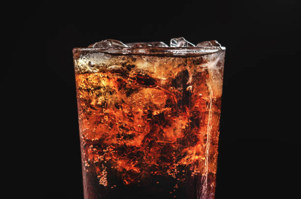 istock close up ice cola in glass and bubble soda on black background 858865368