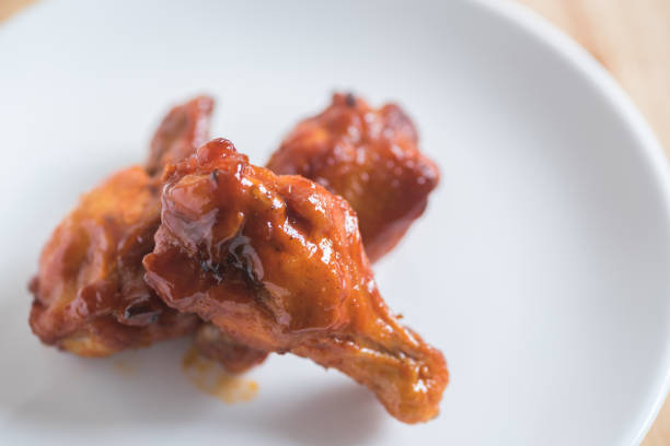 istock spicy BBQ chicken wing in white plate 858871634