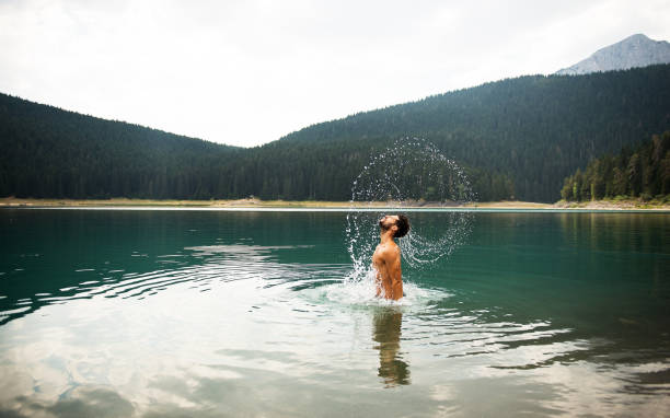 istock Man enjoying mountain lake. 858872060