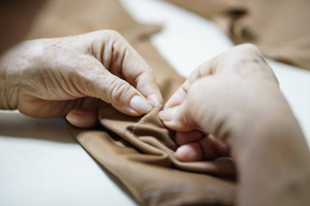 istock grandma hand needle and sewing making cloth 858881778
