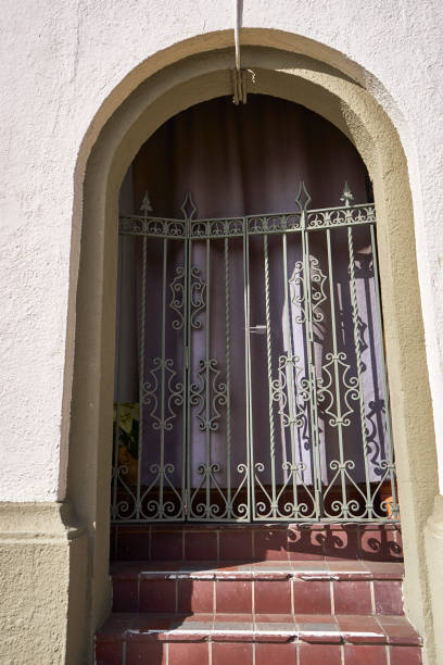 istock ornamental double-gated entryway into residence under archway 858885378