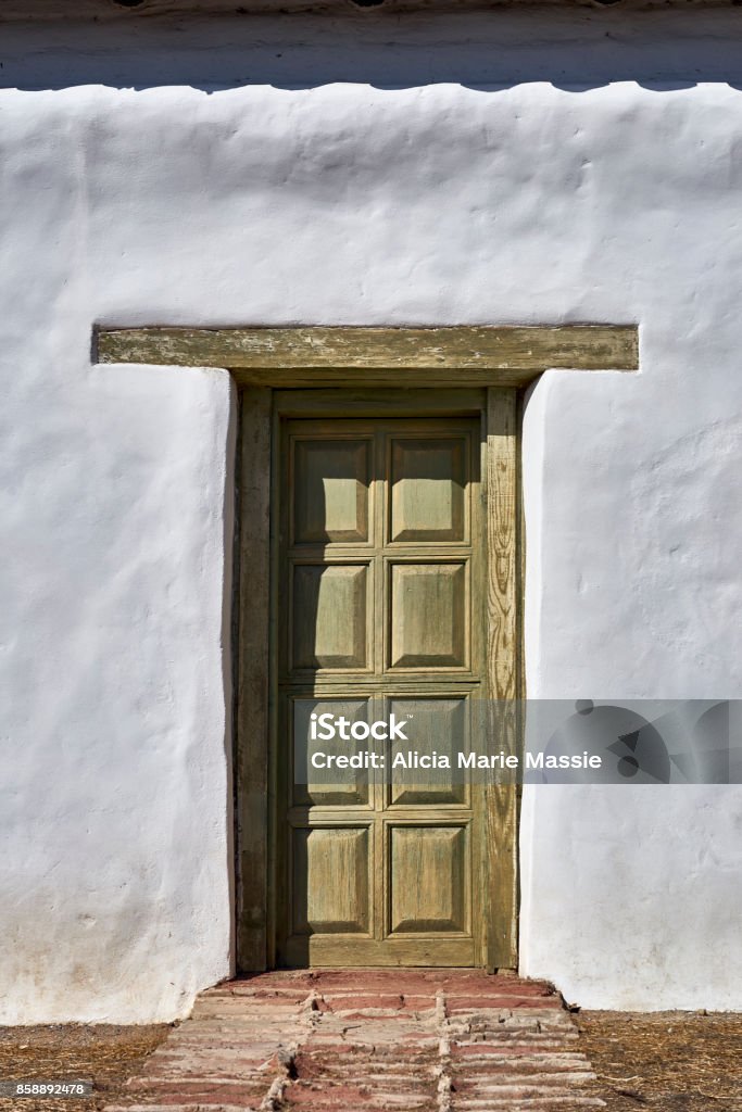 exterior doorway of adobe structure new replacement door for century-old building Adobe - Material Stock Photo