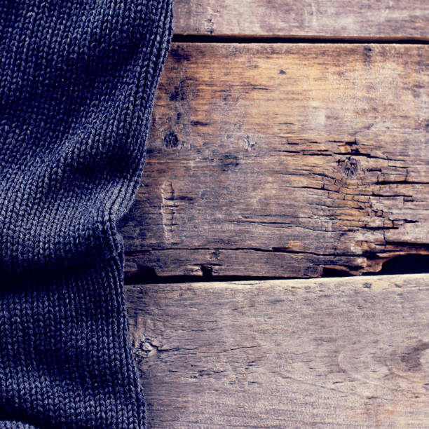 istock knitted plaid, sweater on old wooden boards 858894932