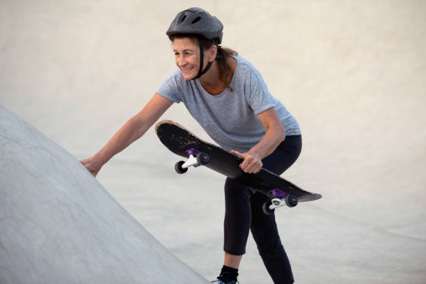istock Active senior woman skateboarding outdoors at skateboard pool. 858895254