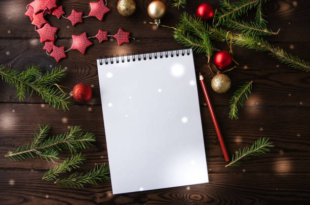 istock White empty notepad paper with christmas decoration on a wooden background. Flat lay. 858902386