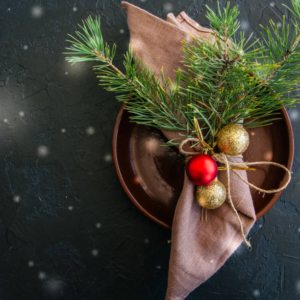istock Christmas table setting with festive decorations over black background with copy space. 858902412