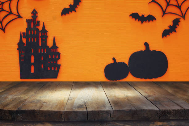 istock Halloween holiday concept with empty rustic table over orange background. Ready for product display montage 858905000