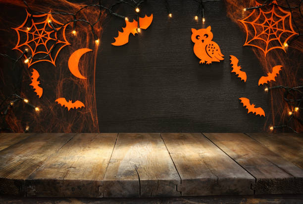 istock Empty rustic table in front of Halloween holiday background. Ready for product display montage 858905198