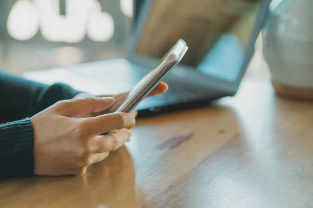 istock Businesswoman  working with modern devices, laptop computer and mobile phone in coffee shop,woman's hands using smart phone in interior, woman at her workplace using technology . 858905992