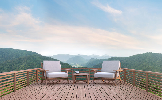 Wood balcony with mountain view 3d rendering image. There are wood floor.Furnished with fabric and wooden furniture. There are wooden railing overlooking the surrounding nature and mountain