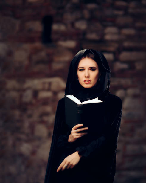 istock Beautiful Witch Princess Reading a Spell Book 858906742