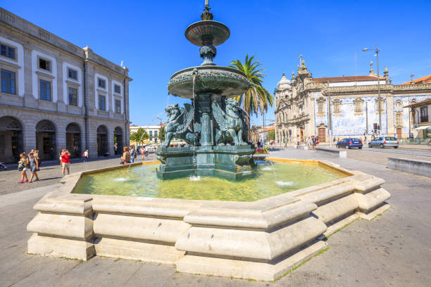 Fountain of Lions Porto Porto, Portugal - August 11, 2017: Fountain of Lions, 19th century fountain, in Parade Leitao Square and Carmo church famous for azulejos on background. Historical city of Oporto. santa justa lift portugal stock pictures, royalty-free photos & images