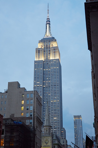 New York - September 11, 2016: Empire State Building from Fifth Avenue illuminated in the evening in New York. From 1931 was the tallest world's building for 40 years.