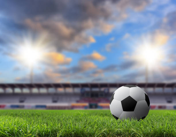 istock Soccer ball on green stadium. 858924422