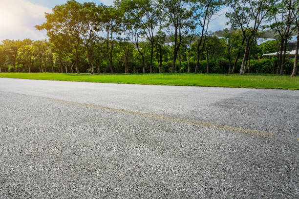 istock asphalt road and green tree in countryside 858924482