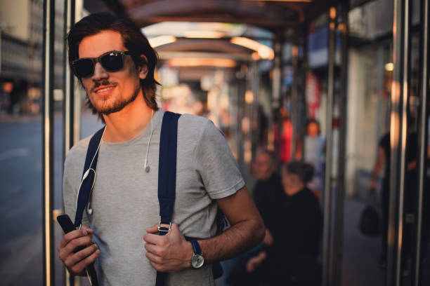 istock Man waiting bus at station 858928342