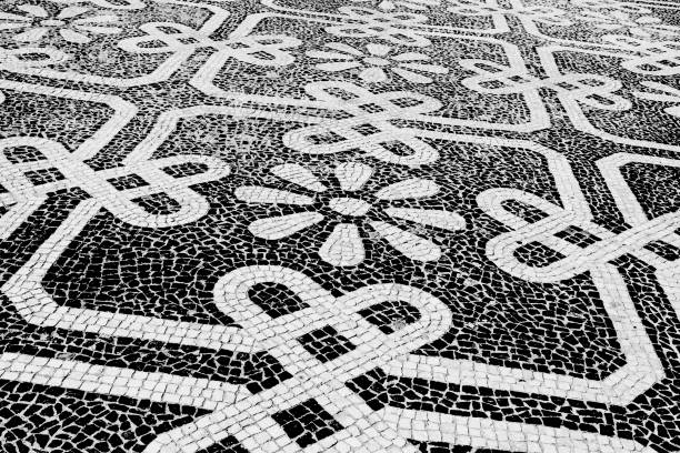 Traditional style Portuguese pavement, designed with black and White stones of basalt and limestone, used in pedestrian areas of Portugal