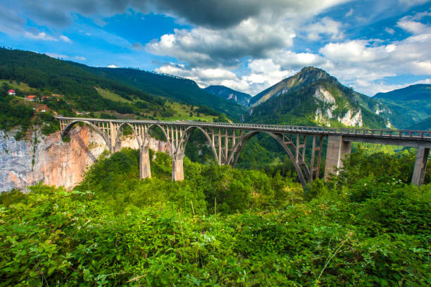 istock Stone bridge across the deep river canyon. 858928950