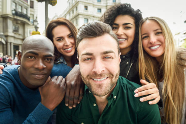 istock Multiracial group of young people taking selfie 858935200