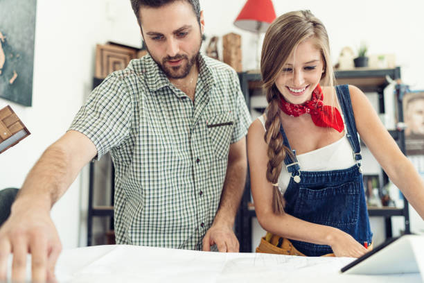 istock Man and woman crafters discussing project in the workshop. 858945246