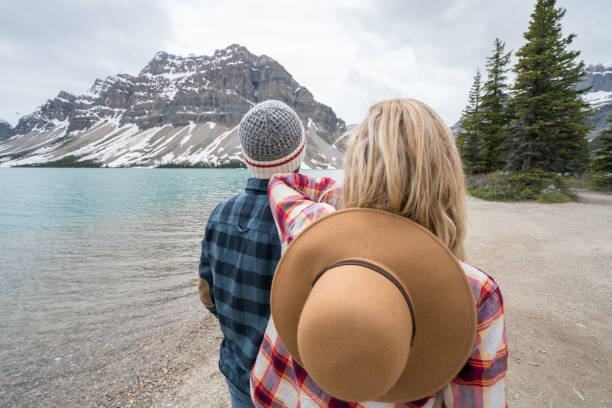 istock Young couple relaxing by the lake 858945718