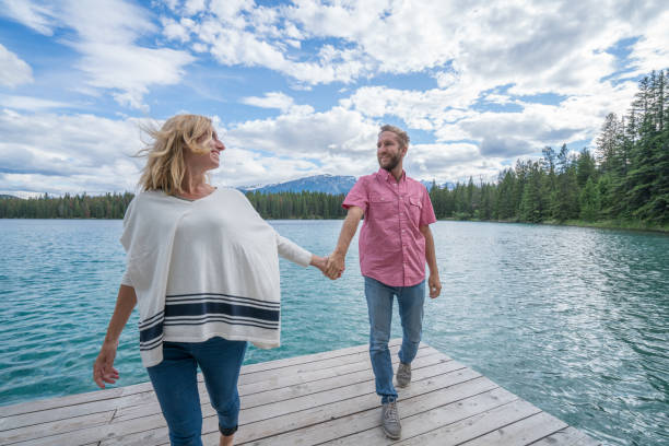 istock Young couple relaxing on lake pier 858951784
