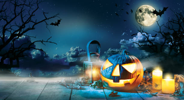 istock Spooky halloween pumpkin on wooden planks 858952284