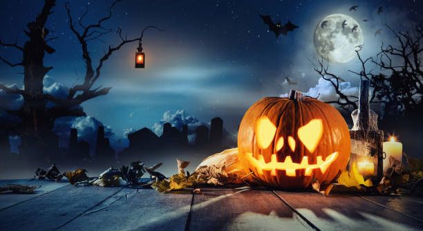 istock Spooky halloween pumpkin on wooden planks 858952304