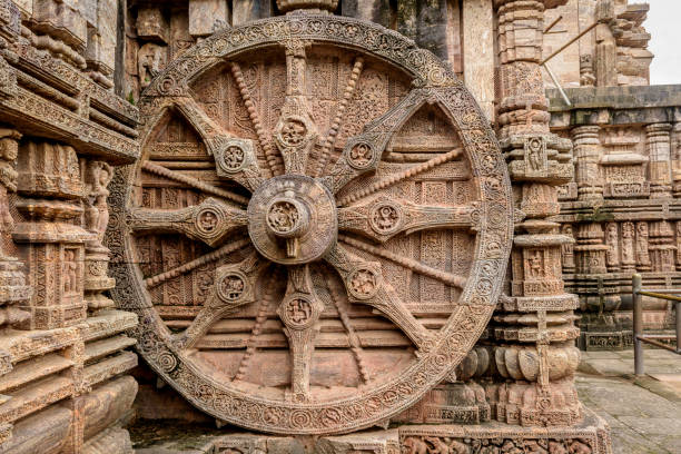 Stone wheel in the ancient  Hindu Sun Temple Intricate carvings on a stone wheel in the ancient  Hindu Sun Temple at Konark, Orissa, India. 13th Century AD chariot wheel at konark sun temple india stock pictures, royalty-free photos & images