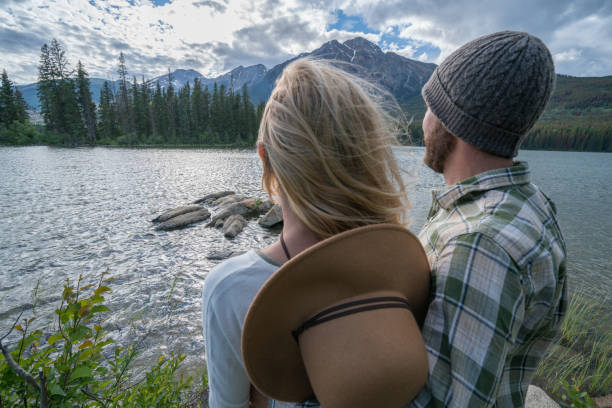 istock Young couple overlooking mountain lake 858956166