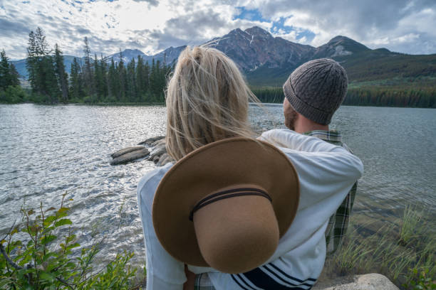 istock Young couple overlooking mountain lake 858956178