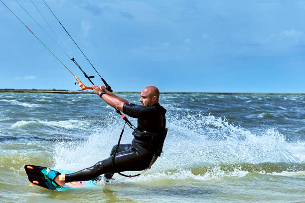istock Man riding a kite surfing on the waves in the summer. 858959196