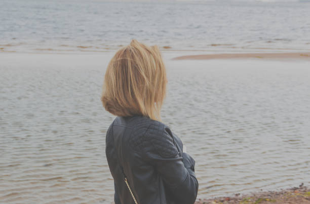 istock on the beach on a cloudy day walks an attractive girl 858959552