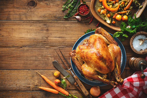 Christmas or Thanksgiving turkey on rustic wooden table