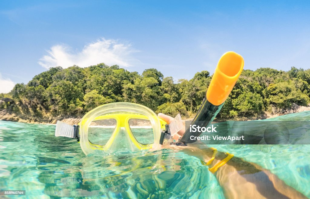 Adventurous guy taking photo of snorkeling mask underwater - Adventure travel lifestyle enjoying happy fun moment at Similan Islands beach - Trip around world nature wonders - Warm turquoise filter Snorkel Stock Photo