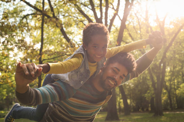 istock African American father with daughter on meadow. 858962992