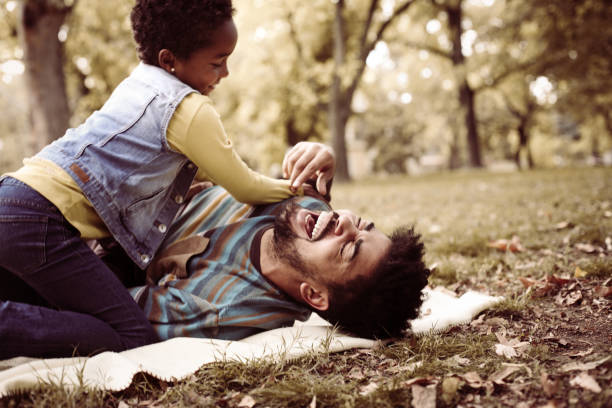 istock African American daughter and father in meadow. 858963848