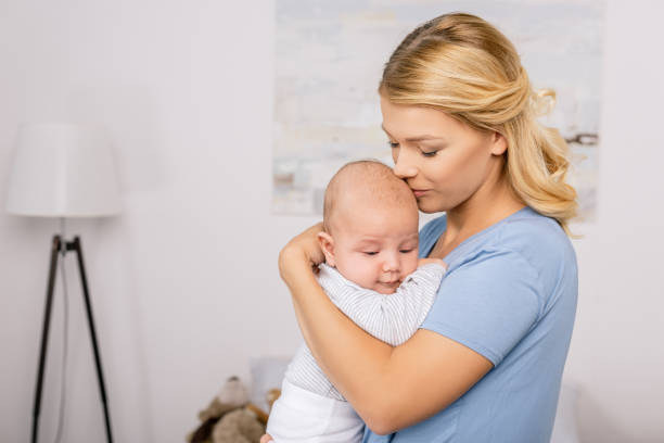 istock mother holding baby 858967570