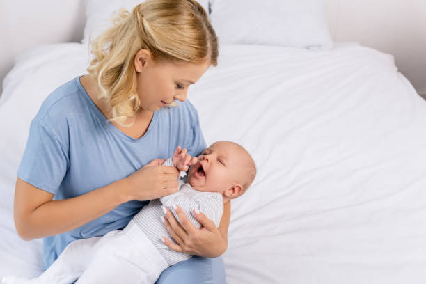 istock mother holding baby 858967718
